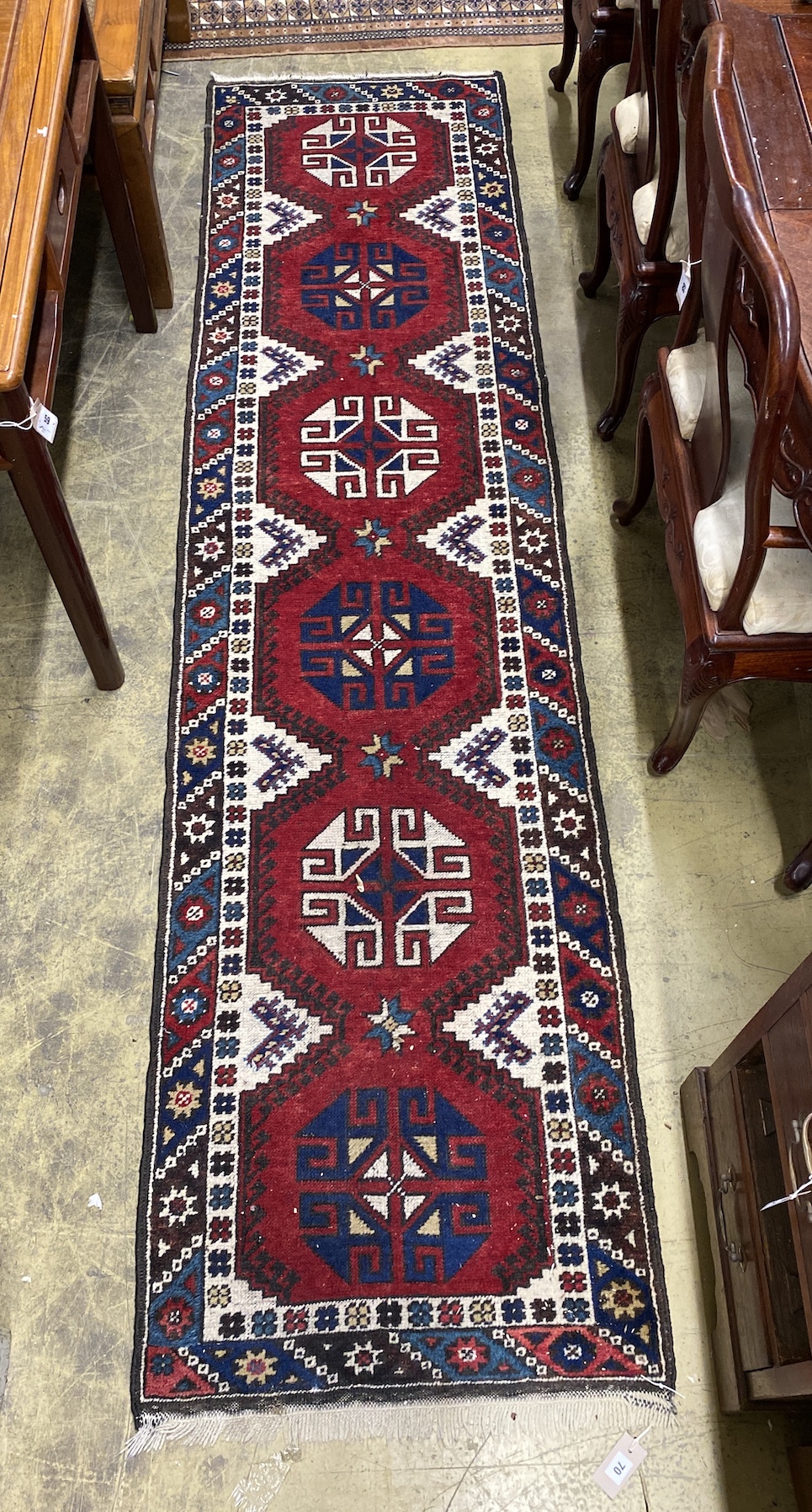 A Caucasian style red ground runner, 274 x 72cm